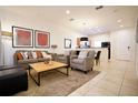 Bright living room with gray sofas, a coffee table, and open floor plan at 3004 Red Ginger Rd, Kissimmee, FL 34747