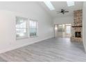Bright living room with fireplace, wood-look floors, and sliding glass doors at 4548 Summergrove Ave, Orlando, FL 32812