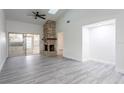 Spacious living room with stone fireplace and gray vinyl flooring at 4548 Summergrove Ave, Orlando, FL 32812