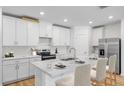 Modern kitchen with white cabinets, quartz countertops, and island with seating at 3510 Rutland Ln, Haines City, FL 33844