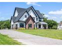 Modern farmhouse exterior with a gravel driveway at 4508 Packard S Ave, Saint Cloud, FL 34772