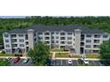 Exterior view of a three-story apartment building with parking at 3174 Feltrim Pl # 201, Kissimmee, FL 34747