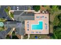 Aerial view of community pool and clubhouse with surrounding landscape at 3174 Feltrim Pl # 201, Kissimmee, FL 34747