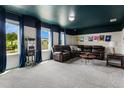 Spacious game room with leather sectional sofa, popcorn machine, and a dark blue ceiling at 2874 Stanza Ct, Kissimmee, FL 34746