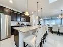 Spacious kitchen with granite countertops, stainless steel appliances, and an island with seating at 8914 Zurich Ln, Kissimmee, FL 34747