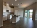 Modern kitchen with granite countertops, white cabinets, and tile floors at 2577 Great Heron Ave, Saint Cloud, FL 34773