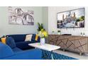 Living room with blue sofa and large TV at 4326 Scene Ln, Kissimmee, FL 34746
