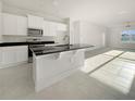 Modern kitchen featuring stainless steel appliances and a large island at 3744 Sagefield Dr, St Cloud, FL 34773