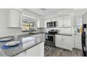Renovated kitchen featuring modern appliances and granite countertops at 1009 Loves Point Dr, Leesburg, FL 34748