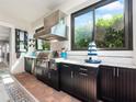 Outdoor kitchen with granite countertops and stainless steel appliances at 4904 W Fountainwood Dr, St Cloud, FL 34772