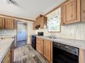 Modern kitchen with wood cabinets, granite countertops, and stainless steel appliances at 40407 Sunset Dr, Eustis, FL 32736