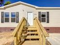 Newly built home with wooden steps and railing at 40407 Sunset Dr, Eustis, FL 32736