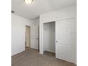 Bright bedroom with carpet flooring, double door closet, and access to another room at 1167 Foreshore Ln, Haines City, FL 33844