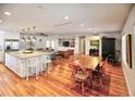 Open concept kitchen with island and hardwood floors at 2955 Lolissa Ln, Winter Park, FL 32789