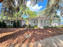 Gray house with landscaping, walkway, and detached structure at 4790 Anderson Rd, Orlando, FL 32812