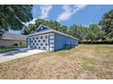Blue house with white garage door and large yard at 1112 Royal Marquis Cir, Ocoee, FL 34761