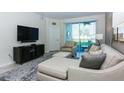 Living room with sectional sofa and large flat-screen TV at 4731 Clock Tower Dr # 101, Kissimmee, FL 34746