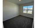 Simple bedroom with dark gray carpeting at 3927 Malawi Trl, Saint Cloud, FL 34772