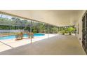 Enjoy this refreshing pool and patio area, complete with a screened enclosure for added privacy at 965 Tuskawilla Rd, Winter Springs, FL 32708