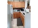 Galley kitchen with wood cabinets and granite counters at 933 W Oak Ridge Rd # 933 B, Orlando, FL 32809