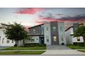 Modern home with stone accents in a row of similar houses at 2965 Fable St, Kissimmee, FL 34746
