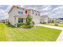 Two-story house with a landscaped front yard and attached garage at 418 Anne St, Deland, FL 32724