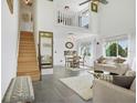 Bright living room with high ceilings, loft, and modern furniture at 59 Chippingwood Ln, Ormond Beach, FL 32176