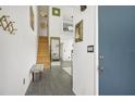Bright entryway with tiled floors, wooden staircase, and a bench at 59 Chippingwood Ln, Ormond Beach, FL 32176