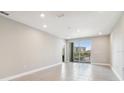 Spacious living room with tile floors and access to a balcony at 7557 Laureate Blvd # 6208, Orlando, FL 32827