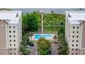 Aerial view of condo community with pool and lake at 6312 Buford St # 303, Orlando, FL 32835