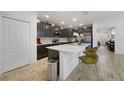 Modern kitchen with dark cabinetry, quartz countertops, and an island at 875 Fillmore Ct, Davenport, FL 33837
