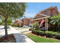 Townhomes with lush landscaping and American flags at 3587 Casalta Cir, New Smyrna Beach, FL 32168