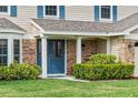 Inviting front entrance with double doors, brick accents, and lush landscaping at 4436 Yachtmans Ct, Orlando, FL 32812