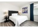Bedroom with a king-size bed and dark headboard at 1136 Castle Pines Ct, Reunion, FL 34747