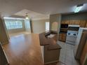 Kitchen with light wood cabinets, laminate countertops and tile floor at 3446 Soho St # 304, Orlando, FL 32835
