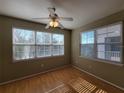 Bright bedroom with wood floors and two large windows at 3446 Soho St # 304, Orlando, FL 32835