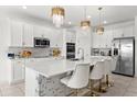 Modern kitchen with large island, white cabinets, and stainless steel appliances at 3846 Cabo Rojo Dr, Saint Cloud, FL 34772