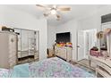 Bright bedroom with mirrored closet doors and TV at 3846 Cabo Rojo Dr, Saint Cloud, FL 34772