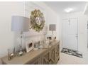 Inviting entryway with decorative console table and stylish lamps at 2862 Mosshire Cir, St Cloud, FL 34772