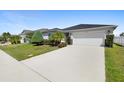 Beautiful curb appeal with a two-car garage and lush landscaping at 2862 Mosshire Cir, St Cloud, FL 34772