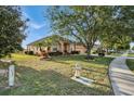 One story house with mature trees and a well maintained lawn at 4319 Dinner Lake Blvd, Lake Wales, FL 33859