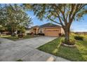 One-story house with attached garage and manicured lawn at 4319 Dinner Lake Blvd, Lake Wales, FL 33859