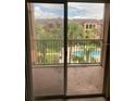 Balcony view of a community pool and lush landscaping at 5500 Metrowest Blvd # 304, Orlando, FL 32811