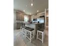 Modern kitchen with an island and stainless steel appliances at 2590 Cliff Way, Saint Cloud, FL 34771