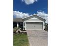House exterior featuring a two-car garage and landscaped yard at 2590 Cliff Way, Saint Cloud, FL 34771