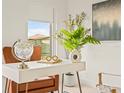 Modern home office featuring a white desk and a comfortable chair at 6368 Chorus Dr, Mascotte, FL 34753