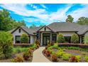 Elegant home with manicured landscaping and walkway at 35635 High Pines Dr, Eustis, FL 32736