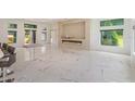 Open living area with marble floors and linear fireplace at 35635 High Pines Dr, Eustis, FL 32736