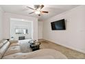 Spacious living room featuring a large sectional sofa and flat-screen TV at 200 Southern Pecan Cir # 105, Winter Garden, FL 34787
