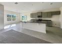 Modern kitchen with grey cabinets, granite countertops, and an island at 3696 Sagefield Dr, St Cloud, FL 34773